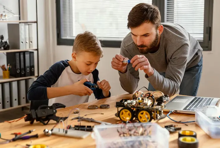 برد آردوینو چیست؟ کاربرد و معرفی Arduino 3 father son making robot 23 2148863387 1 11zon