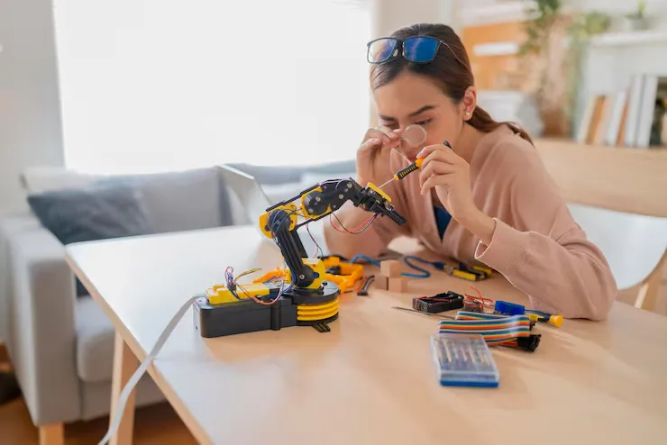 برد آردوینو چیست؟ کاربرد و معرفی Arduino 4 smart asian female programer learning robot arm ai coding electronic board cable stem steam she try testing her autonomous robotic arm with sensors via arduino platform home 609648 2806 3 11zon